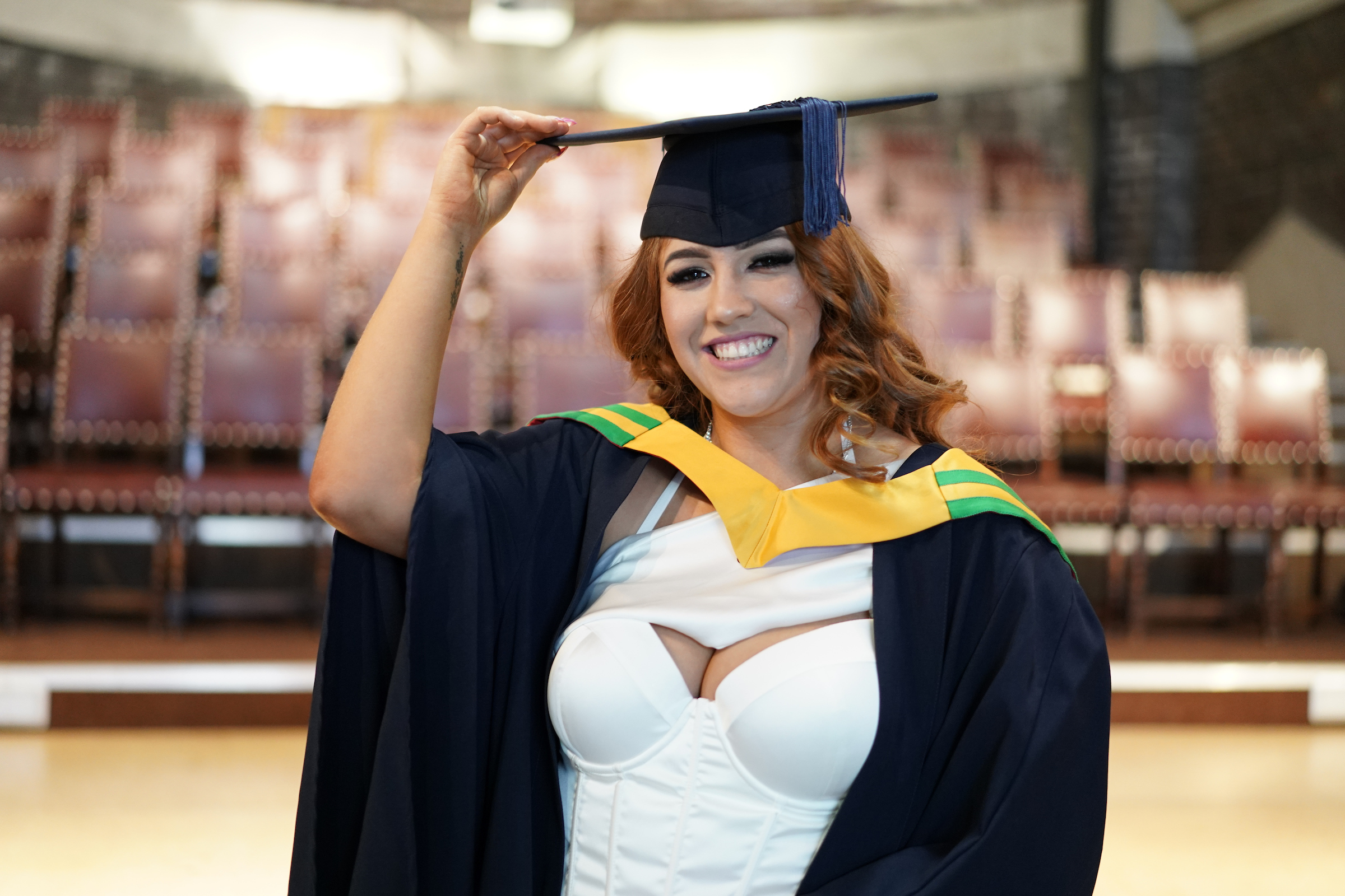 sarah benson smiling touching cap